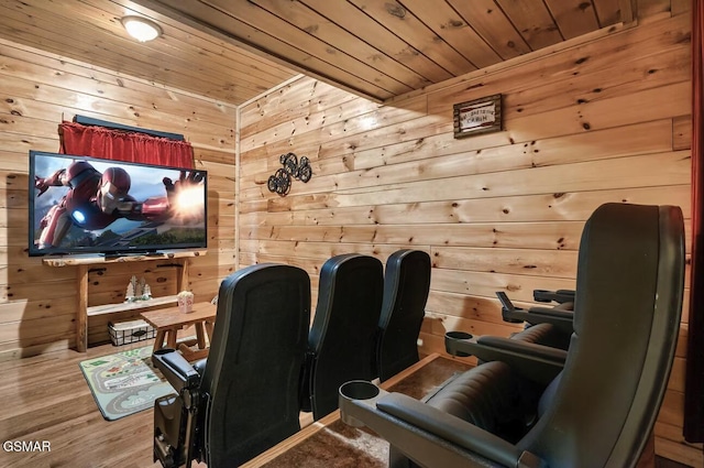 home theater room featuring wooden walls, wood ceiling, and wood finished floors