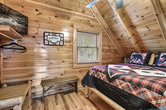 bedroom with hardwood / wood-style flooring, wooden ceiling, and wood walls