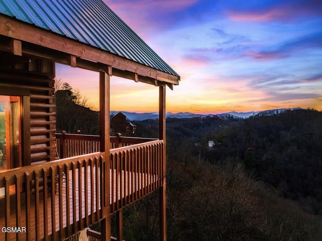 deck at dusk featuring a mountain view