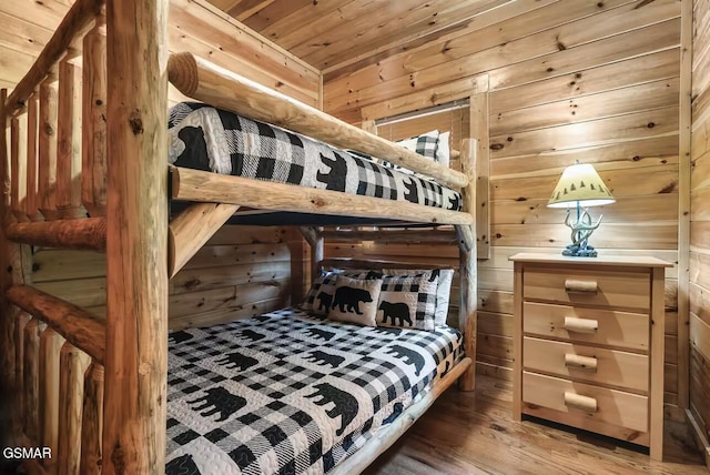bedroom featuring wood finished floors, wood walls, and wooden ceiling
