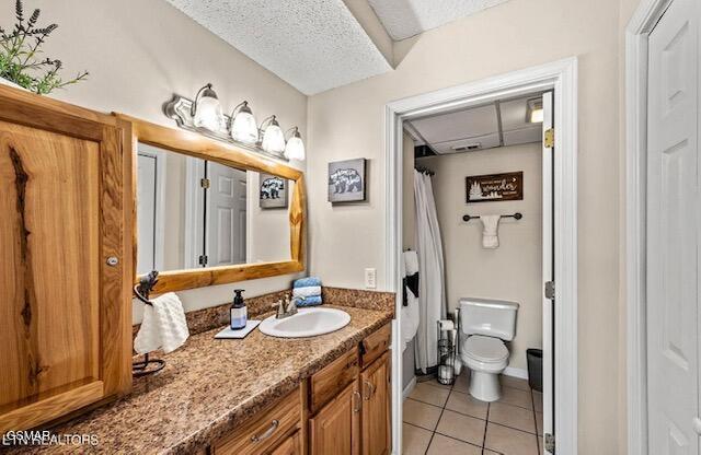 102 Baskins Creek Byp Unit 104, Gatlinburg, TN 37738 - full bath featuring vanity, tile patterned floors, toilet, and a textured ceiling