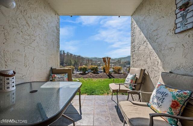 102 Baskins Creek Byp Unit 104, Gatlinburg, TN 37738 - balcony with a patio area and outdoor dining space