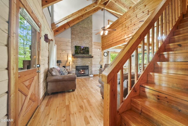 2126 Loafers Glory Way, Gatlinburg, TN 37738 - stairway with a fireplace, wood walls, beam ceiling, high vaulted ceiling, and hardwood / wood-style floors