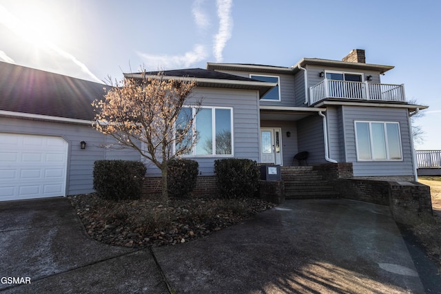 view of front of home with a balcony and a garage