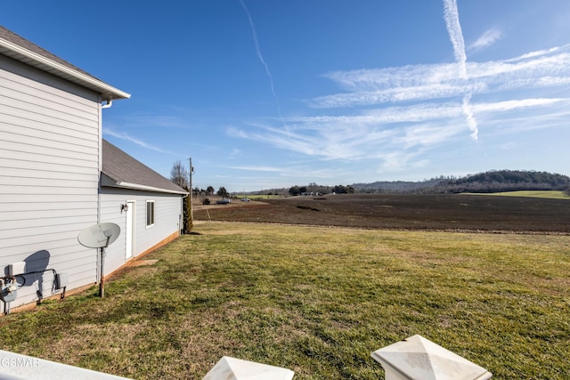 view of yard with a rural view