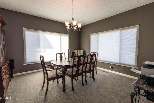 carpeted dining room with a textured ceiling and an inviting chandelier