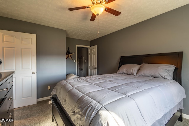 carpeted bedroom featuring ceiling fan and a textured ceiling