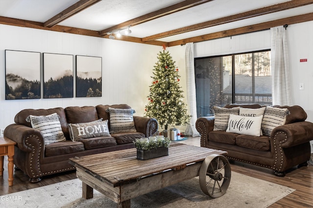 living room featuring beamed ceiling and dark hardwood / wood-style flooring