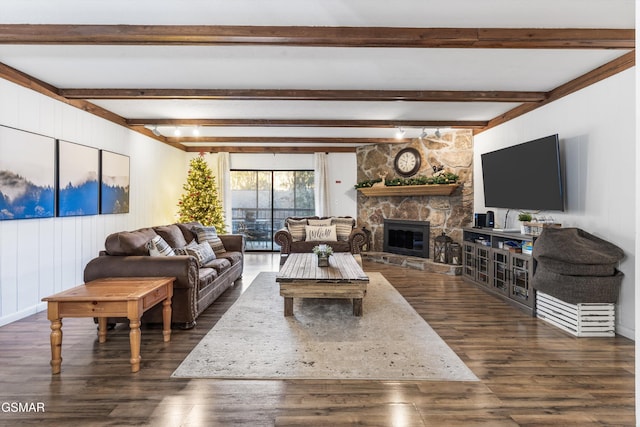 living room with a fireplace, dark hardwood / wood-style flooring, and beamed ceiling