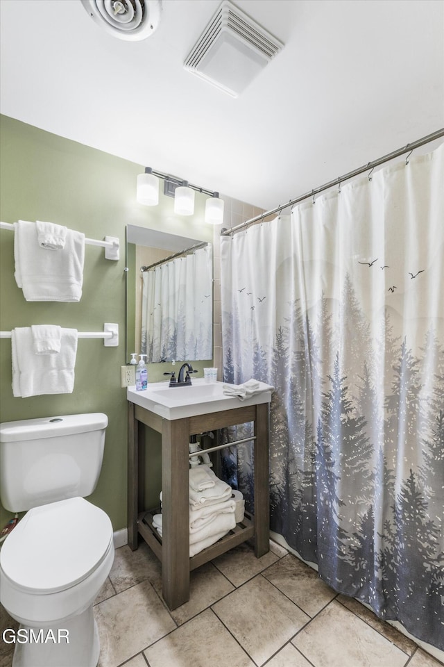 bathroom featuring vanity, toilet, and walk in shower