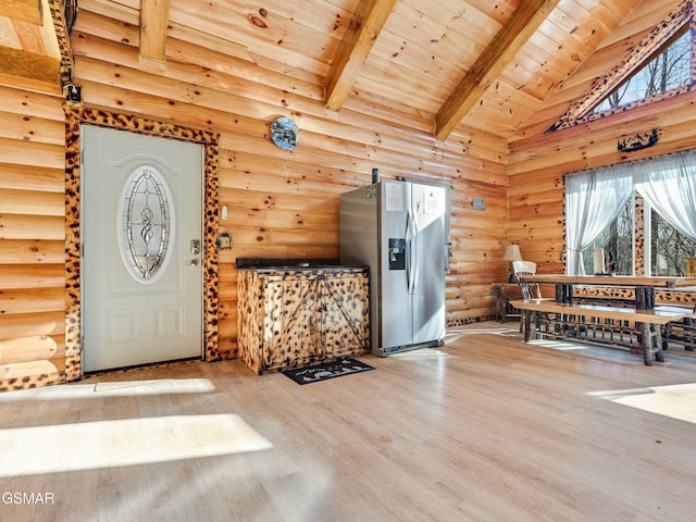 foyer entrance featuring wood-type flooring, rustic walls, lofted ceiling with beams, and wooden ceiling