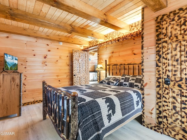 bedroom featuring wood ceiling, wood-type flooring, wooden walls, and beam ceiling