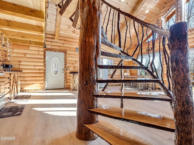 staircase with beamed ceiling, wood-type flooring, high vaulted ceiling, and wood ceiling