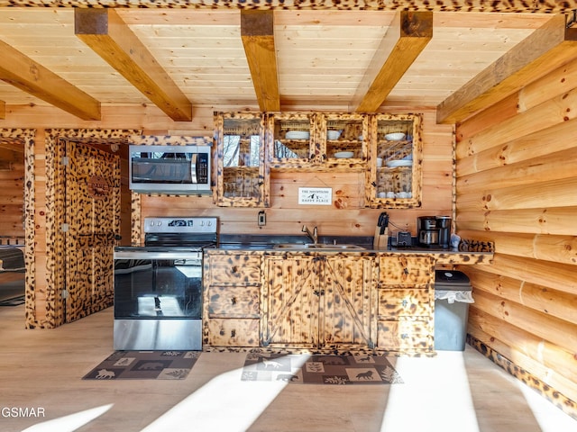 kitchen with wooden ceiling, appliances with stainless steel finishes, sink, and wood walls