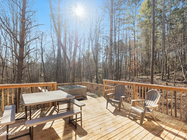 wooden deck featuring a hot tub