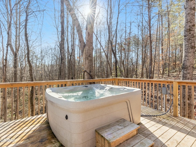 wooden deck with a hot tub