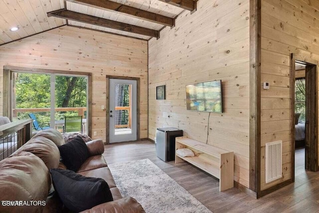 living room featuring high vaulted ceiling, dark hardwood / wood-style floors, wooden ceiling, beamed ceiling, and wood walls