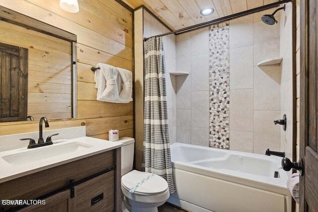 full bathroom featuring vanity, shower / bath combo with shower curtain, toilet, and wood walls