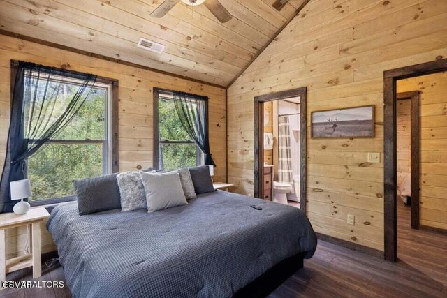 bedroom with multiple windows, wood ceiling, vaulted ceiling, and wood walls