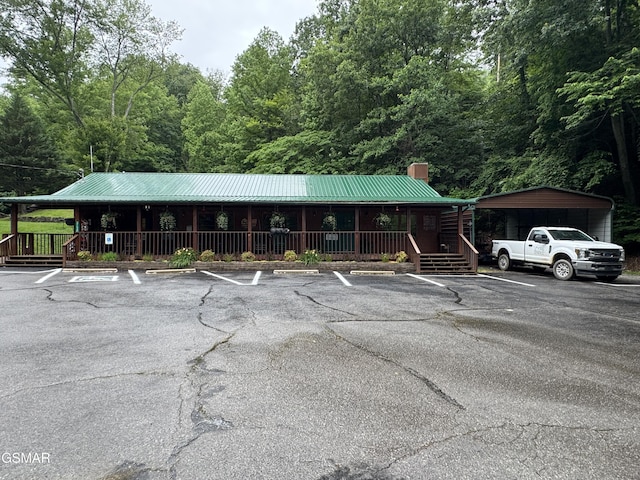 3114 Hatcher Top Rd, Sevierville, TN 37862 - view of front of home featuring a porch, uncovered parking, a chimney, and metal roof