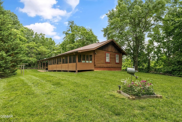 3114 Hatcher Top Rd, Sevierville, TN 37862 - view of side of home with log siding, a vegetable garden, a yard, and a sunroom
