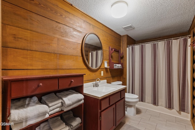3114 Hatcher Top Rd, Sevierville, TN 37862 - bathroom with vanity, toilet, a textured ceiling, wood walls, and a shower with shower curtain