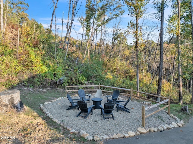 view of yard featuring a fire pit and a forest view