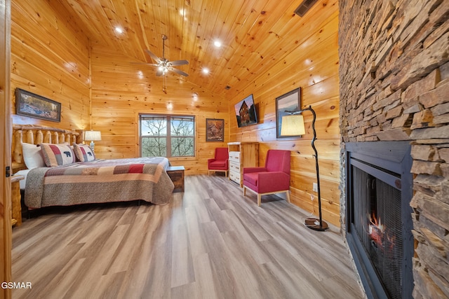 bedroom with a fireplace, high vaulted ceiling, light hardwood / wood-style flooring, and wood ceiling