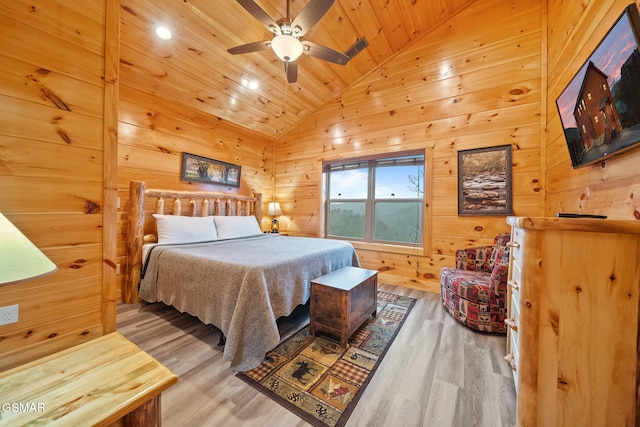 bedroom with ceiling fan, wooden ceiling, wood walls, vaulted ceiling, and hardwood / wood-style flooring