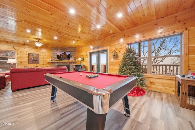 game room featuring french doors, wooden walls, ceiling fan, pool table, and light hardwood / wood-style floors