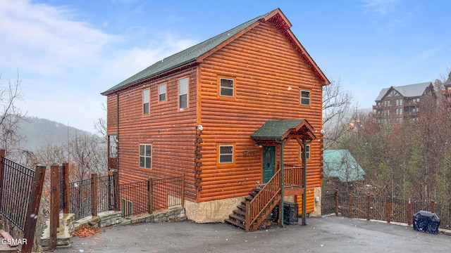 rear view of house featuring a mountain view