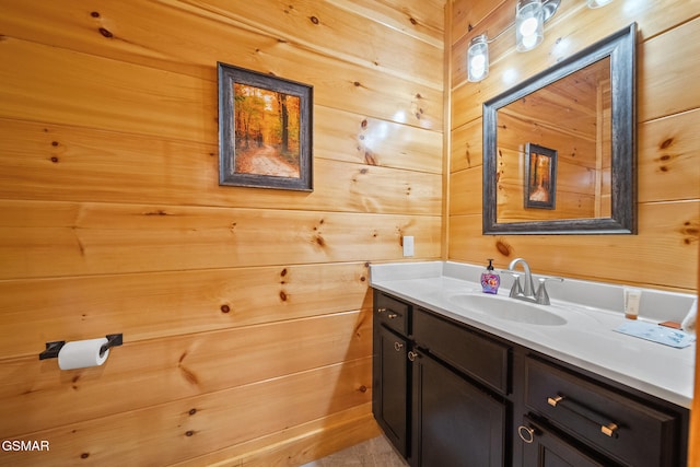 bathroom featuring wooden walls and vanity