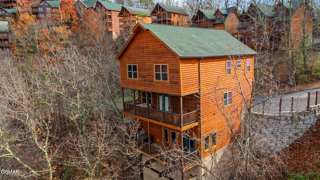 rear view of property with a balcony