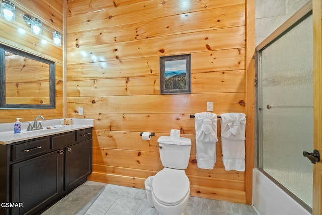 full bathroom with wood walls, toilet, vanity, and combined bath / shower with glass door