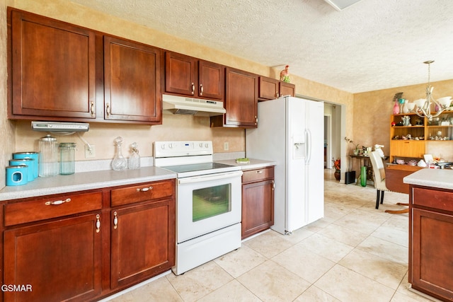 kitchen featuring light countertops, a textured ceiling, under cabinet range hood, and white appliances