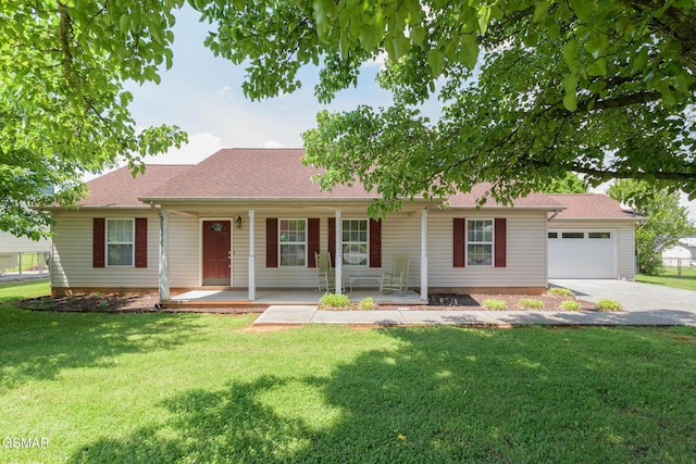 ranch-style house featuring a porch, a garage, driveway, and a front yard