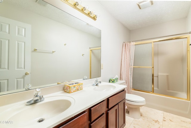 full bath featuring visible vents, a sink, double vanity, and shower / bath combination with glass door
