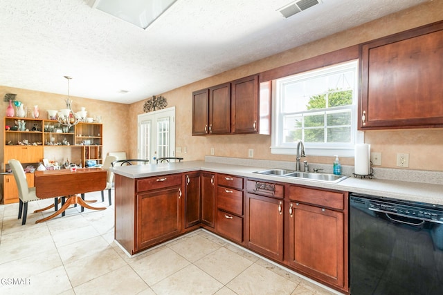 kitchen featuring visible vents, a sink, light countertops, a peninsula, and black dishwasher