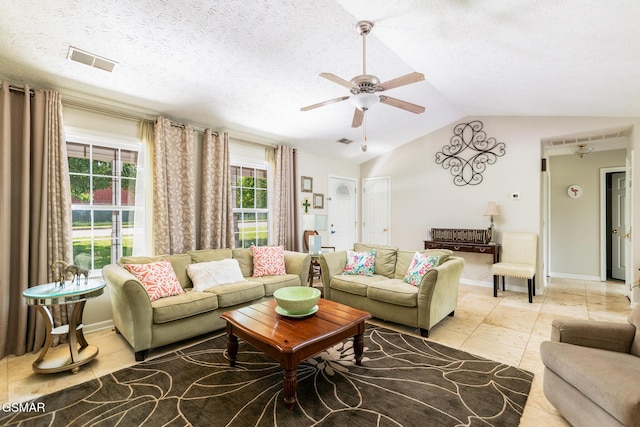living area with ceiling fan, lofted ceiling, light tile patterned flooring, and visible vents