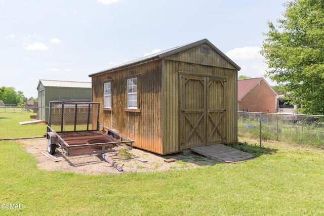 view of shed featuring fence