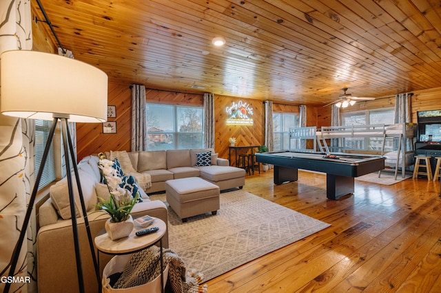 410 Oak Sky Way, Sevierville, TN 37876 - living room with wood walls, healthy amount of natural light, wooden ceiling, pool table, and hardwood / wood-style floors