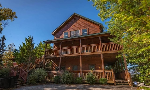 back of house featuring a balcony