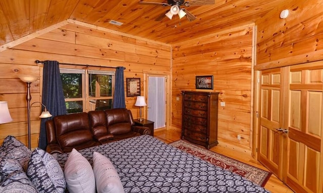 living room with ceiling fan, wood ceiling, and light wood-type flooring