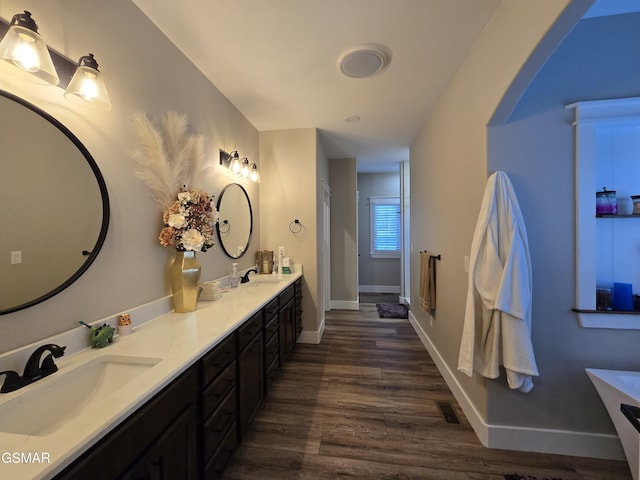 708 Lakeside Ct, Dandridge, TN 37725 - bathroom featuring wood finished floors, double vanity, baseboards, and a shower