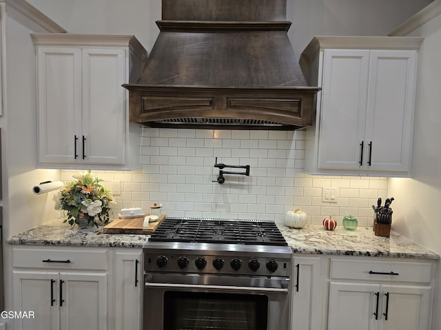 708 Lakeside Ct, Dandridge, TN 37725 - kitchen with stainless steel range, custom exhaust hood, decorative backsplash, and white cabinetry