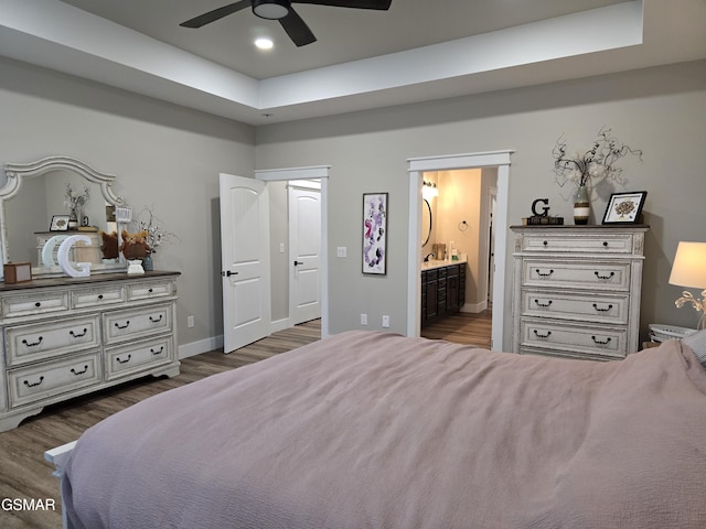 708 Lakeside Ct, Dandridge, TN 37725 - bedroom featuring dark wood-style flooring, ensuite bathroom, a raised ceiling, baseboards, and ceiling fan