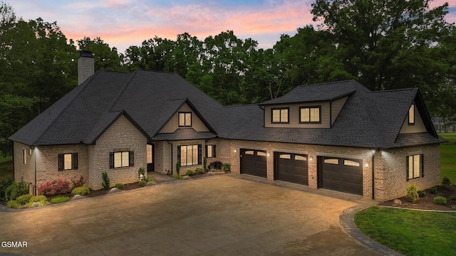708 Lakeside Ct, Dandridge, TN 37725 - view of front of home featuring concrete driveway, a chimney, a garage, and brick siding