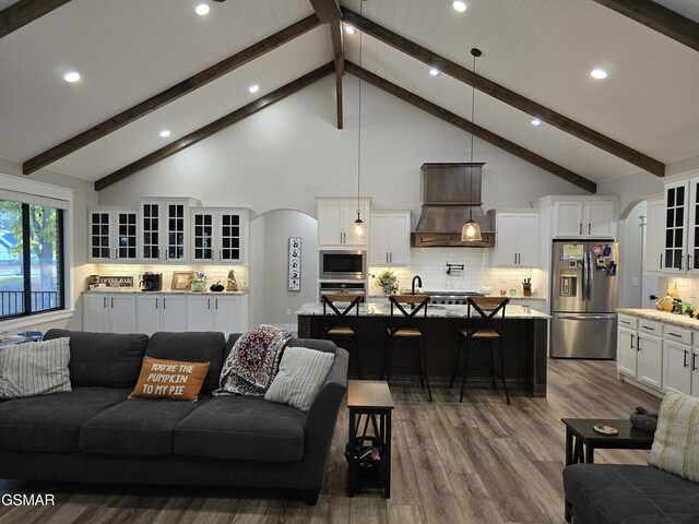 708 Lakeside Ct, Dandridge, TN 37725 - living area with arched walkways, recessed lighting, dark wood-style floors, high vaulted ceiling, and beamed ceiling
