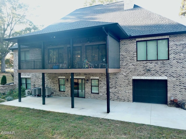708 Lakeside Ct, Dandridge, TN 37725 - view of front facade with a patio, an attached garage, brick siding, and central air condition unit