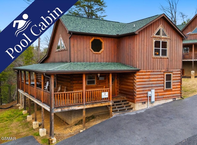 cabin featuring board and batten siding, log exterior, a shingled roof, crawl space, and a porch